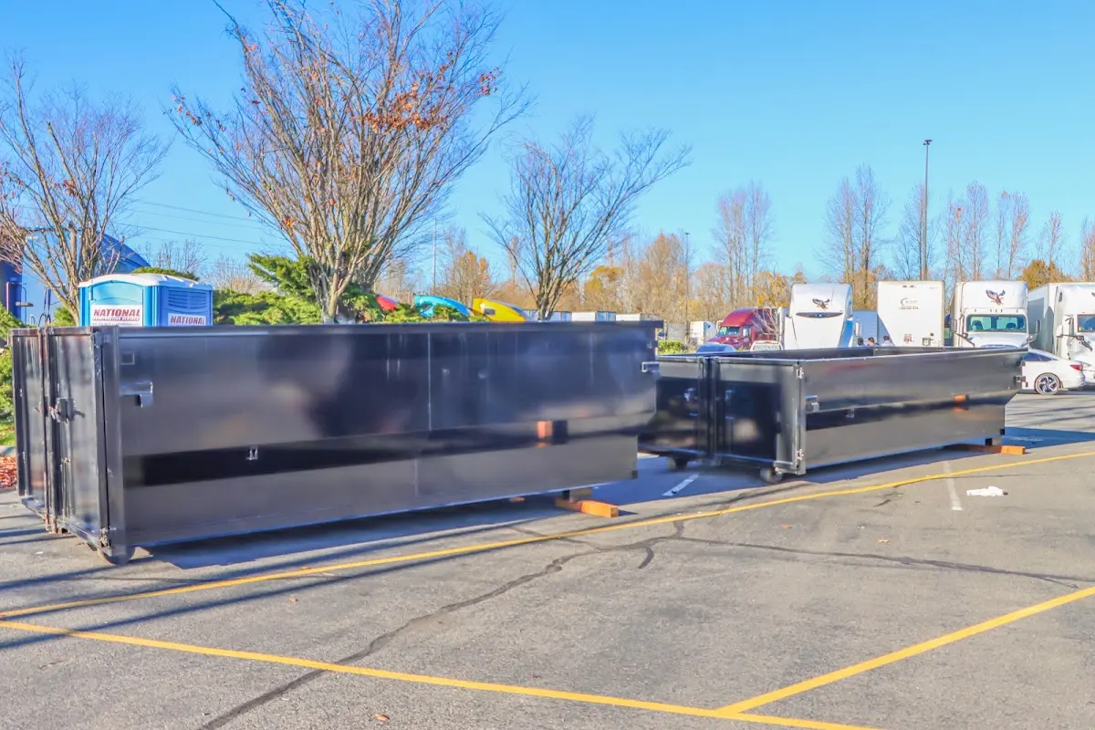 Professional dumpster rental service with roll-off container on residential driveway in Orrville